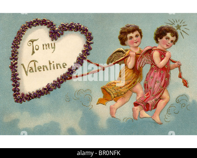 A vintage To My Valentine card with two cherubs pulling a heart Stock Photo