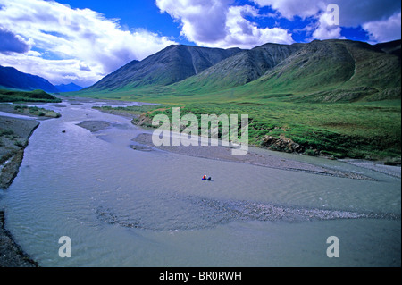 Two whitewater kayakers pack-raft a river through the Brooks Range in the Arctic National Wildlife Refuge, Alaska. Stock Photo