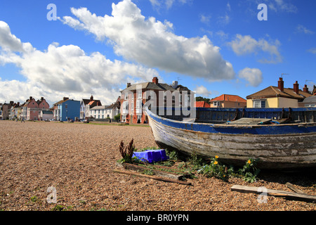 Fishing boat on Aldeburgh beach in front of the row of colourful town houses. Summers day in Suffolk East Anglia. Stock Photo