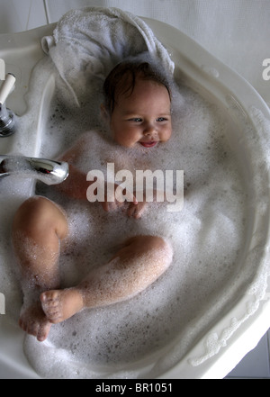 A baby boy takes a bath in his home in Massachusetts. Stock Photo