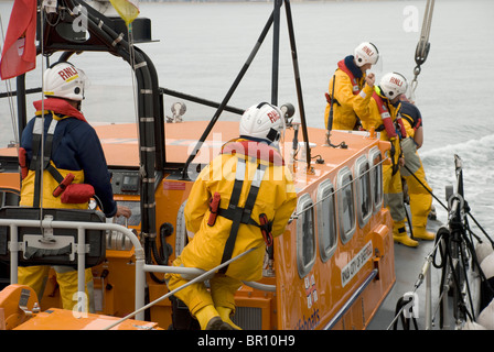poole lifeboat crew carrying out rescue exercises off bournemouth beach Stock Photo
