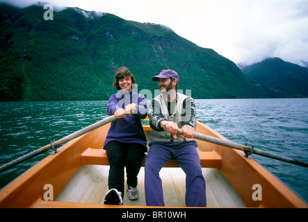 Man and woman row together in the fjords of Norway. Stock Photo