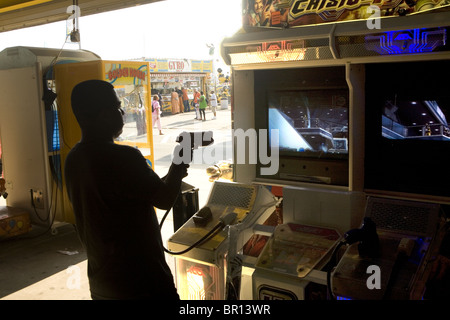 Young man in a video game arcade at Coney Island, Brooklyn, New York Stock Photo