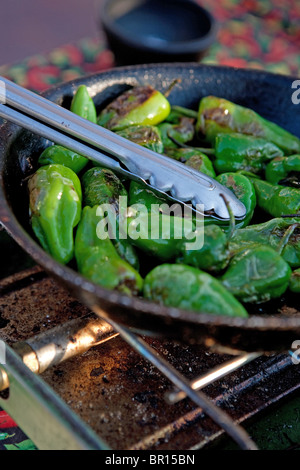 green chile roasting in a pan jalapeno pepper cook cooking fire hot spicy Stock Photo