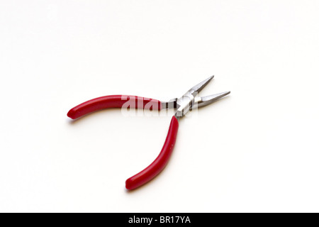 Needle-nose pliers with a red plastic insulated grip Stock Photo