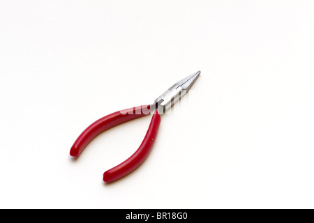 A pair of needlenose pliers with a red plastic insulated grip Stock Photo