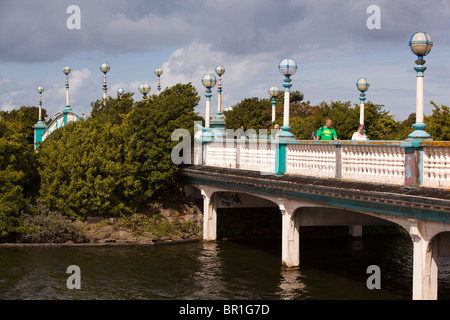 UK, England, Merseyside, Southport, visitors walking on bridge over Marine Lake to seafront Stock Photo