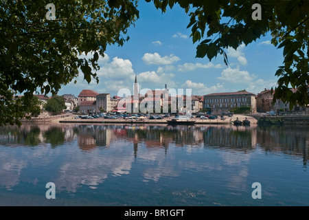 Bergerac, Dordogne, France, seen across the river Dordogne from the south bank, with quayside car parking Stock Photo