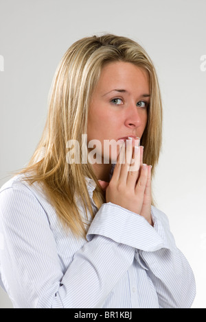 A young woman shows apprehension towards something. Stock Photo