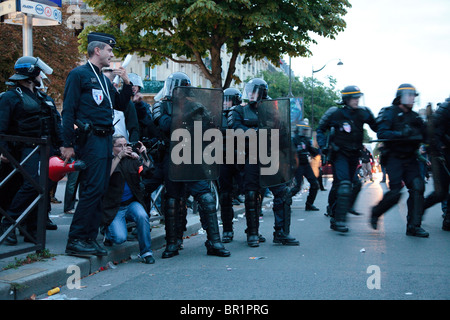 French riot police (CRS) confront protesters, during demonstration over proposed pension reforms, Paris, France, 07/09/10 Stock Photo