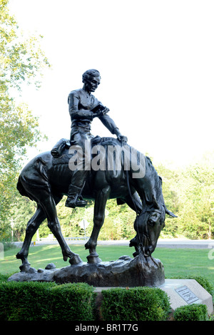 Bronze sculpture of young Abraham Lincoln reading while riding horse in Lincol's New Salem State Historic site Stock Photo