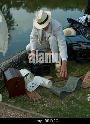 France - 'Chateau de Breteuil', Choisel, French Man Dressed in Traditional Period Costume, victorian age Fancy Dress, at Ball Event , (Journees du Patrimoine) Playing Music BOx beside Pond outside Stock Photo