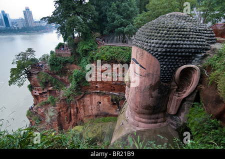 The Dafo or Great Buddha dwarfs visitors, Le Shan, Sichuan Province, China Stock Photo