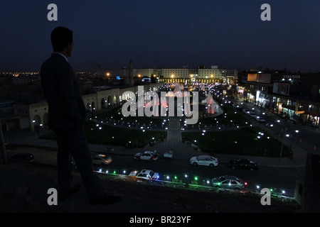 A Kurdish man gazing at downtown from the old citadel in the city of Erbil also spelled Arbil or Irbil the capital city of Kurdistan Region in northern Iraq. Stock Photo
