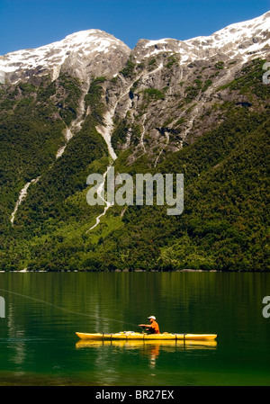 A man fly fishes from a kayak in the Futaleufu river. Stock Photo