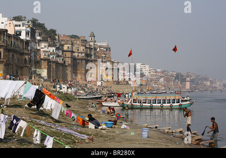 River Ganges with ancient buildings on the bathing ghats at Varanasi, India. Stock Photo