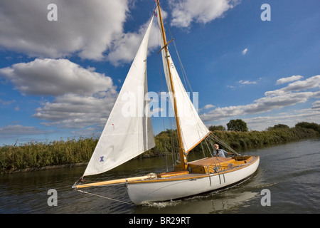 Sailing on the Broads, Norfolk. An old fashioned yacht with gaff rigged sails in The Broads National Park in autumn Stock Photo