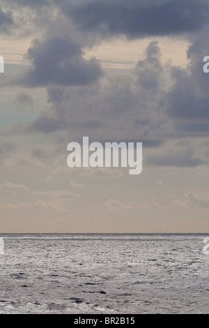 Sea scape, stormy clouds over a sunny sea Stock Photo