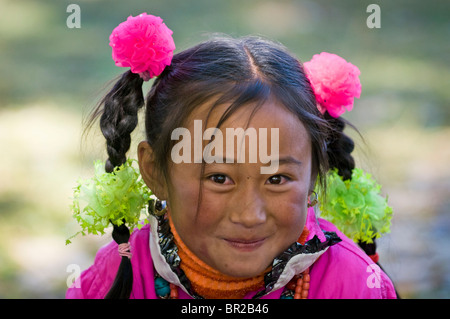 Ethnic Tibetan girl wears hair decorations at weekend festival, Bamei, Sichuan Province, China Stock Photo