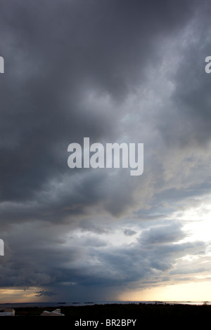 Rainstorm cell clouds rising from horizon , Finland Stock Photo