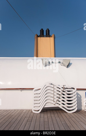 Seven sun loungers stacked on top of each other on the open deck of the P&O cruise ship 'Aurora'. Stock Photo