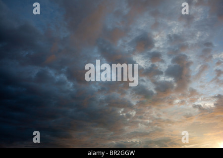 Colorful evening clouds at sky at sunset Stock Photo