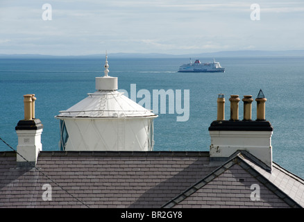 Ferry passing Blackhead Lighthouse, County Antrim, Northern Ireland. Stock Photo