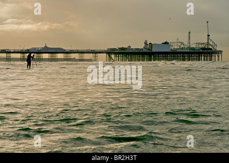 Silhouette of the Palace Pier, now called Brighton Pier, Brighton. Low tide. East Sussex, England Stock Photo