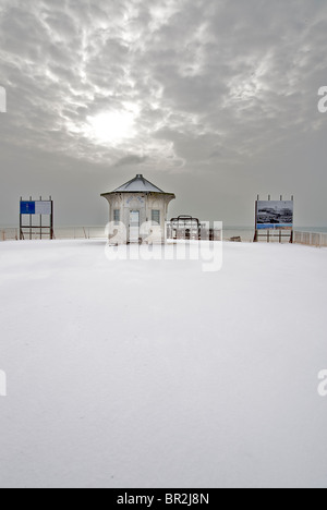 The landward end of Brighton 's otherwise derelict West Pier  in snow. Brighton, East Sussex, England Stock Photo