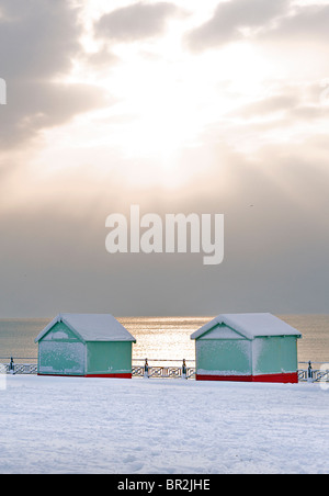 Beach huts on Hove promenade in snow. Winter. Brighton & Hove, East Sussex, England Stock Photo