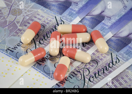 Medicines on a backdrop of UK money. Stock Photo