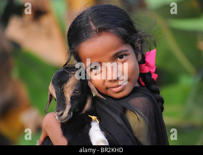 Portrait of an Indian girl with a goat, Kerala, India Stock Photo