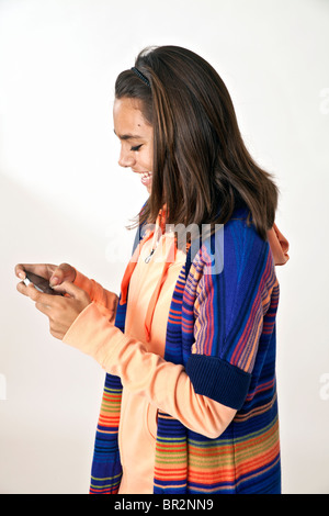 multi ethnic multi racial diversity racially diverse multicultural multi cultural teenage Hispanic girl using iPhone mobile phone. MR © Myrleen Pearson Stock Photo