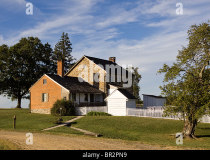 Old brick stone house with white picket fence - Virginia USA Stock Photo