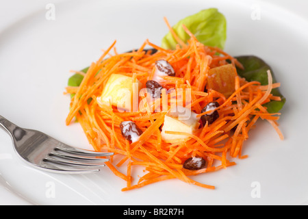 Fresh carrot salad with shredded carrots, raisins, apples and a light curry yogurt dressing. Stock Photo