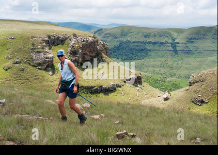Hiker climbing Mount Lebanon, Highmoor nature reserve, uKhahlamba Drakensberg Park, South Africa Stock Photo