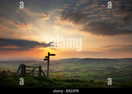 Sunset and signpost from Whitestone Cliff,  along the Cleveland Way Footpath, The North York Moors National Park. Stock Photo