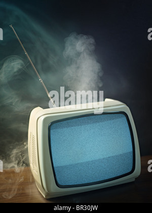 broken tv about to explode. Studio shot, vertical shape, copy space Stock Photo