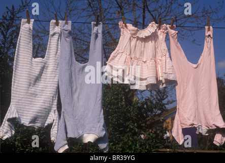 baby clothes hanging on the line - blue for boys and pink for girls Stock Photo