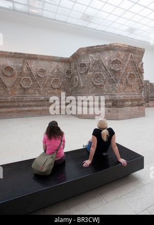 Visitors looking at remains of Palace of Mshatta at Pergamon Museum on Museumsinsel in Berlin Germany Stock Photo