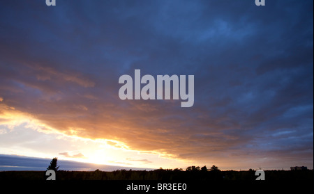 Colorful evening clouds at sky at sunset Stock Photo