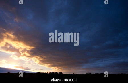 Colorful evening clouds at sky at sunset Stock Photo