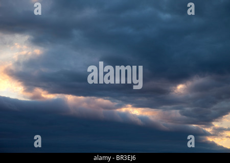 Colorful evening clouds at sky at sunset Stock Photo