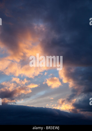 Colorful evening clouds at sky at sunset Stock Photo