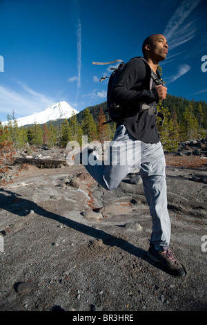 African American man, Cupid Alexander, runs on trail near Mt. Hood in the Cascade Mountains, Oregon. Stock Photo