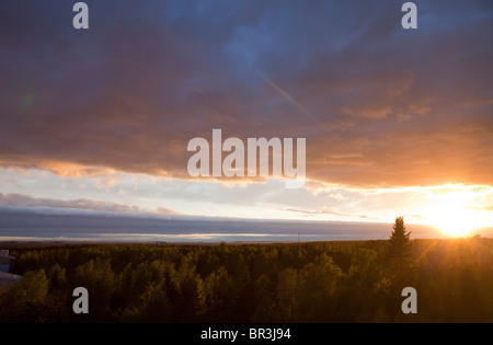 Aerial image of colorful evening clouds and forest at sky at sunset , Finland Stock Photo