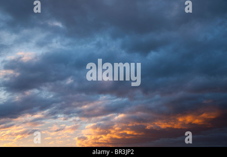 Colorful evening clouds at sky at sunset Stock Photo