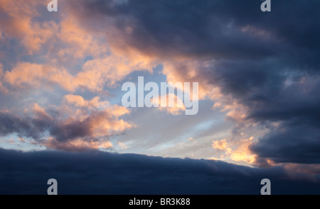 Colorful evening clouds at sky at sunset Stock Photo