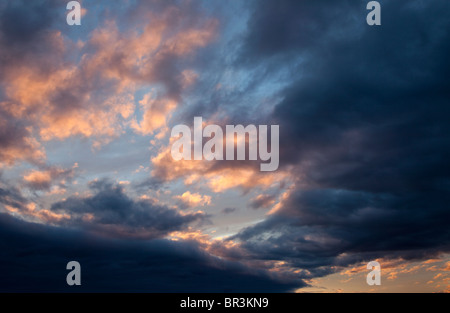 Colorful evening clouds at sky at sunset Stock Photo