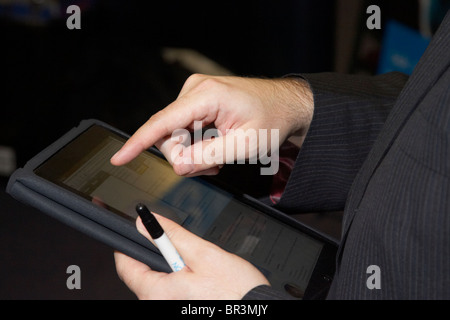 businessman using an apple ipad touchscreen tablet computer Stock Photo